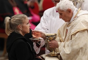 POPE DISTRIBUTES COMMUNION AS HE CELEBRATES CHRISTMAS EVE MASS IN ST. PETER'S BASILICA AT VATICAN