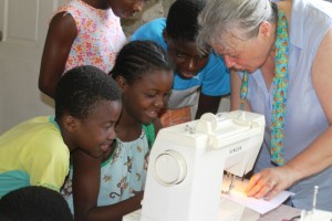 Grandma LaRee teaches sewing to orphans in Haiti