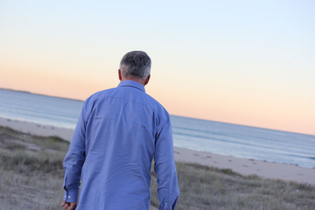 man walking beach