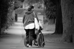 woman pushing wheelchair